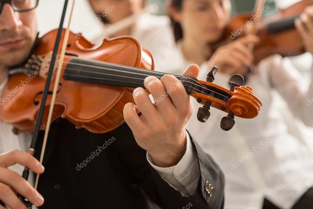 Orchestra on stage performing a dramatic cinematic piece