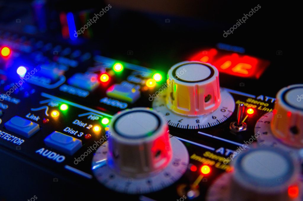 DJ performing electronic music with colorful lights
