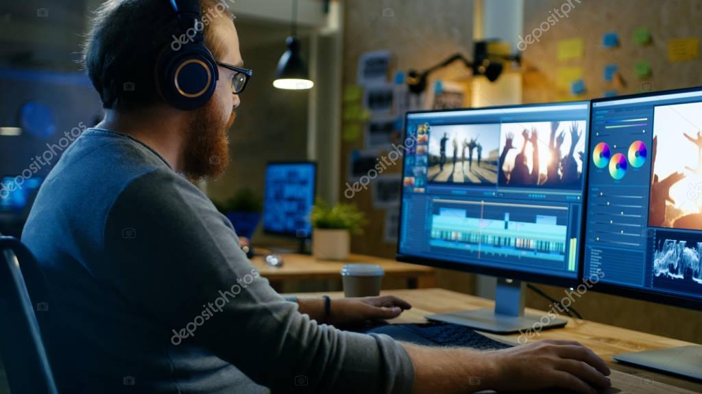 Content creator editing a video with headphones on at a desk