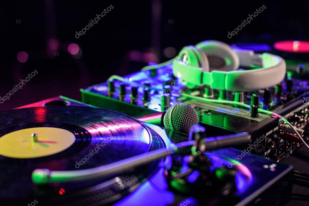 DJ performing with turntables in a packed club