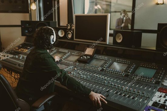 Music producer working in a recording studio on a song mix