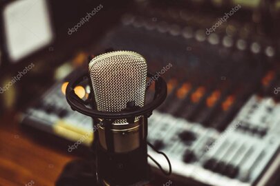 Artist recording vocals in a music studio with colorful lights