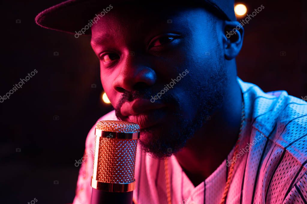 Artist recording vocals into a studio microphone
