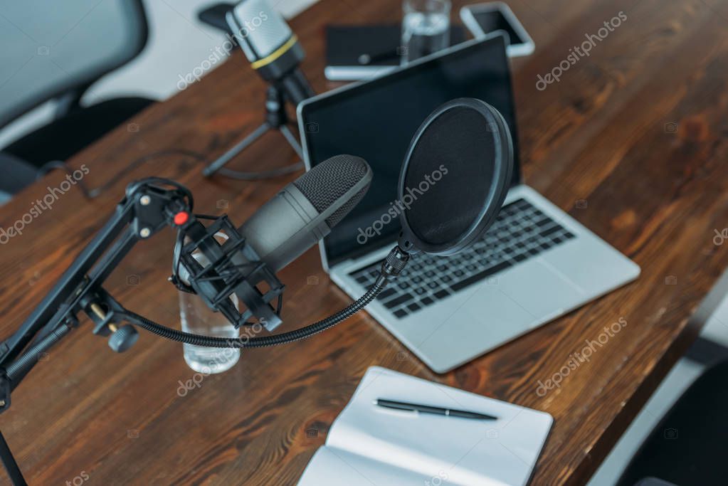 Podcast microphone and headphones set up in a recording studio