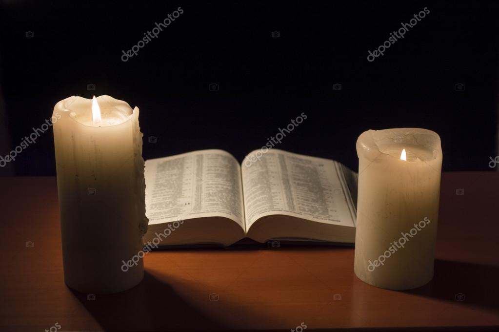 Open Bible and candlelight creating a peaceful prayer atmosphere