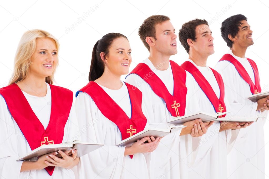 Joyful gospel choir singing on stage with raised hands
