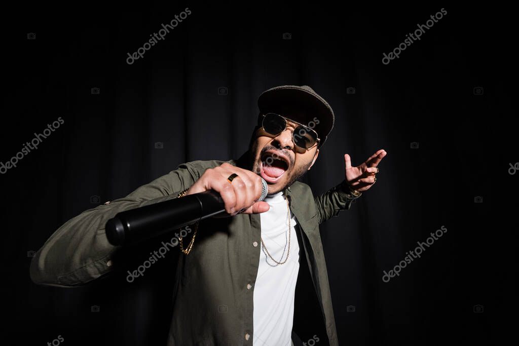 Hip-hop artist recording vocals in a studio