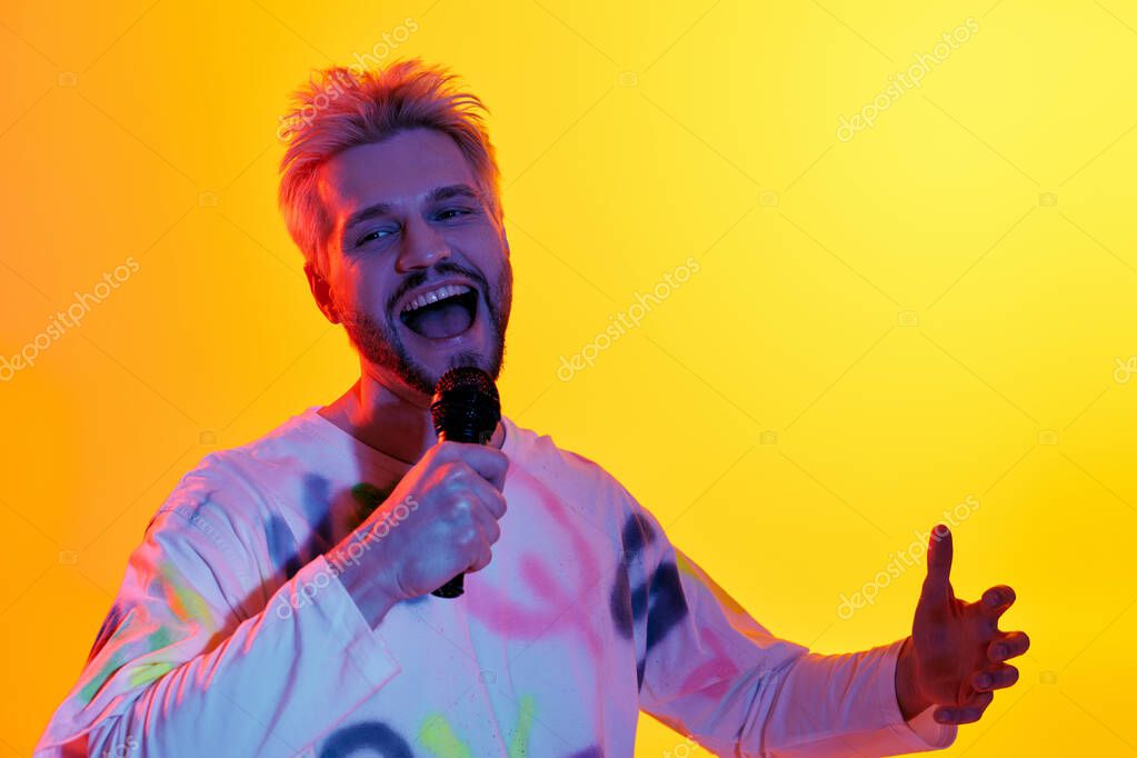Speaker with a microphone encouraging an inspired audience