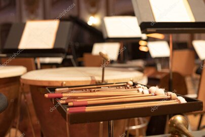 Composer at a studio desk scoring cinematic music on a laptop and keyboard